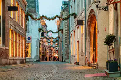 Eine weihnachtlich dekorierte, gepflasterte Altstadtstraße.