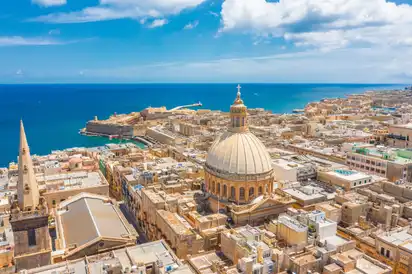 Stadtansicht von Valletta, Malta mit der Kuppel der Karmelitengemeinde und Meer im Hintergrund.