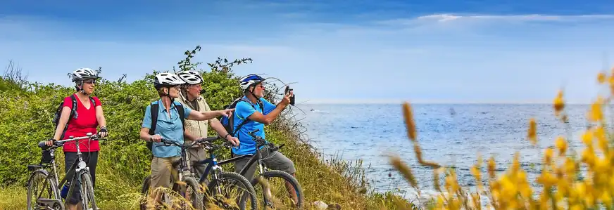Urlauber auf einer Biketour am Meer