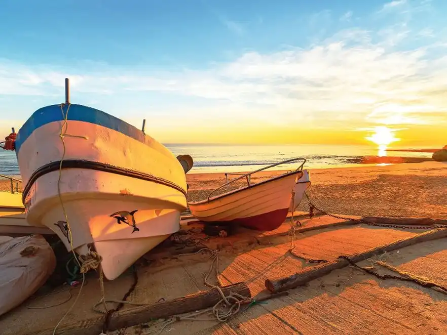 Boats in warm sunset light on the Fisherman's Beach in Albufeira